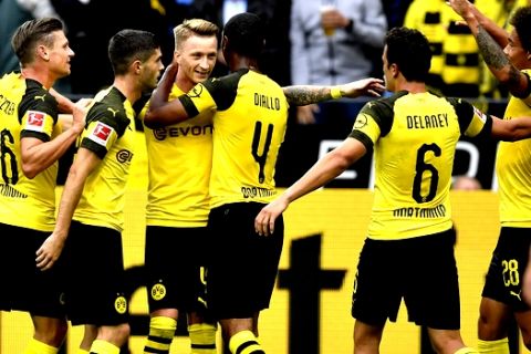 Dortmund's Marco Reus is celebrated by his team after scoring his 100th Bundesliga goal during the German Bundesliga soccer match between Borussia Dortmund and RB Leipzig in Dortmund, Germany, Sunday, Aug. 26, 2018. (AP Photo/Martin Meissner)