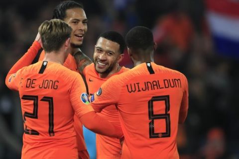 Netherlands' Virgil Van Dijk celebrates with teammates after scoring his side's fourth goal during their Euro 2020 group C qualifying soccer match between Netherlands and Belarus at the Feyenoord stadium in Rotterdam, Netherlands, Thursday, March 21, 2019. (AP Photo/Peter Dejong)