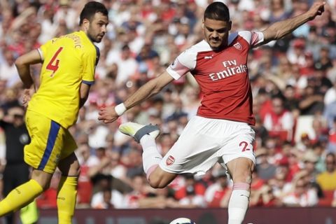 Arsenal's Konstantinos Mavropanos, center, has a shot during the English Premier League soccer match between Arsenal and Crystal Palace at the Emirates Stadium in London, Sunday, April 21, 2019. (AP Photo/Tim Ireland)