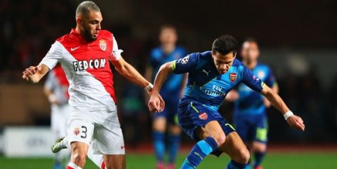 MONACO - MARCH 17:  Alexis Sanchez of Arsenal holds off Layvin Kurzawa of Monaco during the UEFA Champions League round of 16 second leg match between AS Monaco and Arsenal at Stade Louis II on March 17, 2015 in Monaco, Monaco.  (Photo by Michael Steele/Getty Images)