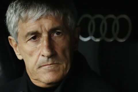 Barcelona's head coach Quique Setien waits for the start of the Spanish La Liga soccer match between Real Madrid and Barcelona at the Santiago Bernabeu stadium in Madrid, Spain, Sunday, March 1, 2020. (AP Photo/Manu Fernandez)