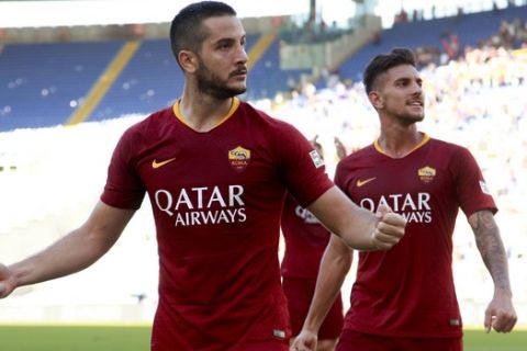 Roma's Kostas Manolas, left, and Lorenzo Pellegrini celebrate their side's 3-1 win at the end of the Serie A soccer match between Roma and Lazio, at the Rome Olympic Stadium, Saturday, Sept. 29, 2018. (AP Photo/Andrew Medichini)