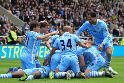  Manchester City's players mob Yaya Toure after scoring the first  goal