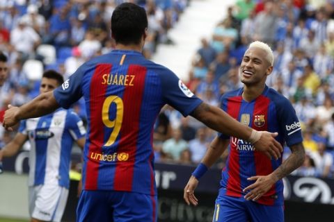 Barcelona's Neymar, right, celebrates with teammate Luis Suarez, left, after scoring during the Spanish La Liga soccer match between Leganes and Barcelona at the Butarque stadium in Madrid, Spain, Saturday, Sept. 17, 2016. (AP Photo/Paul White)