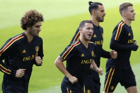 Belgium's Marouane Fellaini, left, Belgium's Eden Hazard, second left, Belgium's Nacer Chadli, second right, and Belgium's Thorgan Hazard warm up during the 2018 soccer World Cup the day before the quarter final World Cup soccer match between Belgium and Brazil at the Guchkovo Stadium in Dedovsk, outside Moscow, Russia, Thursday, July 5, 2018. (AP Photo/Hassan Ammar)