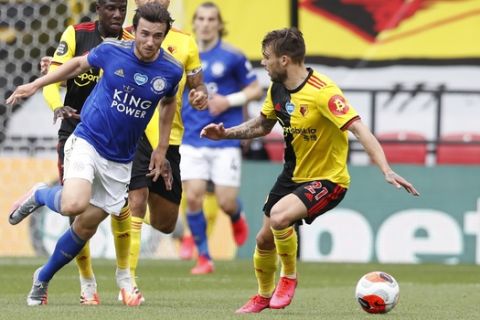 Leicester's Ben Chilwell, left, is challenged by Watford's Kiko Femenia, right, during the English Premier League soccer match between Watford and Leicester City at the Vicarage Road Stadium in Watford, England, Saturday, June 20, 2020. (AP Photo/Alastair Grant, POOL)