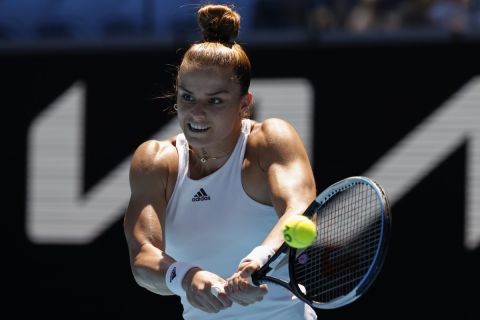Maria Sakkari of Greece makes a backhand return to Jessica Pegula of the U.S. during their fourth round match at the Australian Open tennis championships in Melbourne, Australia, Sunday, Jan. 23, 2022. (AP Photo/Tertius Pickard)