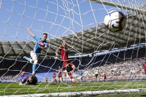 Napoli's Arkadiusz Milik scores a goal that was later disallowed during the Serie A soccer match between Roma and Napoli at the Rome Olympic Stadium Sunday, March 31, 2019. (AP Photo/Andrew Medichini)