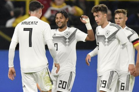 Germany's Kai Havertz. left, celebrates after scoring his side's second goal during the international friendly soccer match between Germany and Argentina at the Signal Iduna Park stadium in Dortmund, Germany, Wednesday, Oct. 9, 2019. (AP Photo/Martin Meissner)