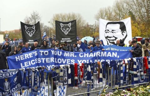 Fans on a memorial walk for those who lost their lives in the Leicester City helicopter crach including Leicester City Chairman Vichai Srivaddhanaprabha ahead of the Premier League match at the King Power Stadium, Leicester, England. Saturday Nov. 10, 2018. (Joe Giddens/PA via AP)