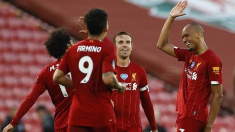 Liverpool's Fabinho, right, celebrates scoring his side's third goal during the English Premier League soccer match between Liverpool and Crystal Palace at Anfield Stadium in Liverpool, England, Wednesday, June 24, 2020. (Phil Noble/Pool via AP)