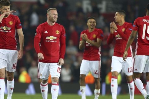 Manchester United's Wayne Rooney, second left celebrates with teammates after the end of the Europa League semifinal second leg soccer match between Manchester United and Celta Vigo at Old Trafford in Manchester, England, Thursday, May 11, 2017. Manchester United drew the match but go through to the final 2-1. (AP Photo/Dave Thompson)