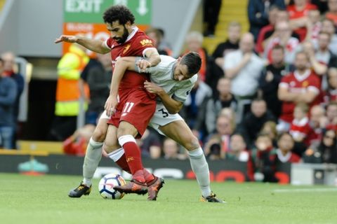 Liverpool's Mohamed Salah, left, and Manchester United's Matteo Darmian, right, battle for the ball during the English Premier League soccer match between Liverpool and Manchester United at Anfield, Liverpool, England, Saturday, Oct. 14, 2017. (AP Photo/Rui Vieira)