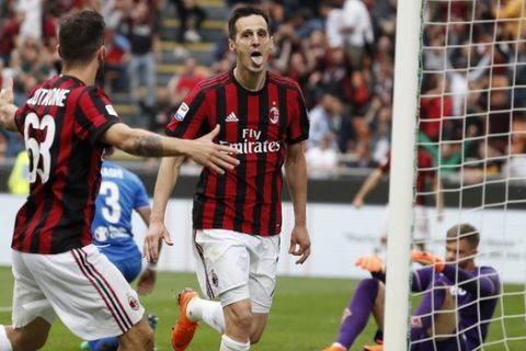 AC Milan's Nikola Kalinic, right, celebrates with his teammate Patrick Cutrone after scoring his side's third goal during the Serie A soccer match between AC Milan and Fiorentina at the San Siro stadium in Milan, Italy, Sunday, May 20, 2018. (AP Photo/Antonio Calanni)