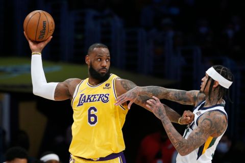 Los Angeles Lakers forward LeBron James (6) is defended by Utah Jazz guard Jordan Clarkson (00) during the first half of an NBA basketball game in Los Angeles, Monday, Jan. 17, 2022. (AP Photo/Ringo H.W. Chiu)