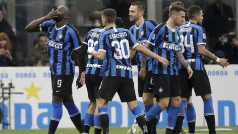 Inter Milan's Romelu Lukaku, left, blows a kiss as he celebrates after scoring his side's fourth goal during a Serie A soccer match between Inter Milan and Genoa, at the San Siro stadium in Milan, Italy, Saturday, Dec. 21, 2019. (AP Photo/Luca Bruno)