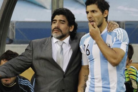 Argentina head coach Diego Maradona, left, Argentina's Sergio Aguero, right, during the World Cup quarterfinal soccer match between Argentina and Germany at the Green Point stadium in Cape Town, South Africa, Saturday, July 3, 2010.  (AP Photo/Gero Breloer)