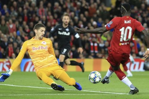 Liverpool's Sadio Mane, right, scores his side's opening goal during the Champions League group E soccer match between Liverpool and Red Bull Salzburg at Anfield stadium in Liverpool, England, Wednesday, Oct. 2, 2019. (AP Photo/Jon Super)