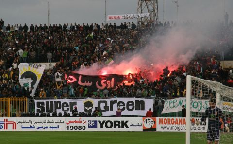 Egyptian fans of Al-Masry light flares during a football match against Al-Ahly in Port Said on February 1, 2012. At least 74 people were killed and hundreds injured when rival fans clashed after the football match, highlighting a security vacuum in post-revolution Egypt. AFP PHOTO/STR (Photo credit should read STR/AFP/Getty Images)