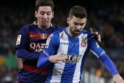 FC Barcelona's Lionel Messi, left, duels for the ball against Espanyol's Victor Alvarez during a Copa del Rey soccer match at the Camp Nou stadium in Barcelona, Spain, Wednesday, Jan. 6, 2016. (AP Photo/Manu Fernandez)
