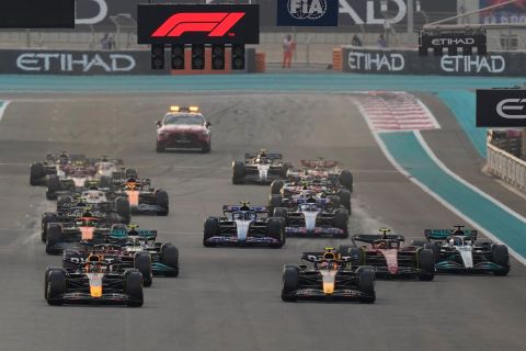 Red Bull driver Max Verstappen of the Netherlands, left, and Red Bull driver Sergio Perez of Mexico lead at the start during the Formula One Abu Dhabi Grand Prix, in Abu Dhabi, United Arab Emirates Sunday, Nov. 20, 2022. (AP Photo/Hussein Malla)