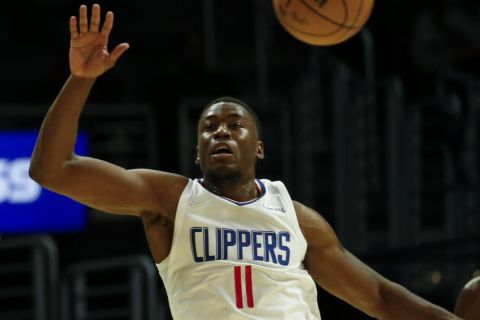 Denver Nuggets guard Austin Rivers (25) passes the ball against Los Angeles Clippers guard Moses Wright (11) during the second half of a preseason NBA basketball game, Monday, Oct. 4, 2021, in Los Angeles. The Clippers won 103-102. (AP Photo/Ringo H.W. Chiu)