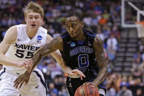 Georgia State guard Kevin Ware (0) drives past Xavier guard J.P. Macura (55) during the first half of an NCAA tournament third round college basketball game, Saturday, March 21, 2015, in Jacksonville, Fla. (AP Photo/Chris O'Meara)