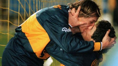 Argentine soccer stars Diego Maradona, right, and Claudio Caniggia kiss after Caniggia scored Boca Juniors' second goal in their 4-1 match against archrival River Plata, Sunday July 14,1996 in Buenos Aires, Argentina. It wasn't the first time the pair have shared such a kiss, last month, a similar kiss sparked criticism from Argentine soccer players and even Chile's national coach who said their behavior set a bad example for children.(AP Photo/O-Telam)
