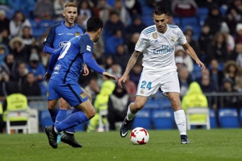 Real Madrid's Daniel Ceballos, right, is challenged by Fuenlabrada defenders during a Spanish Copa del Rey round of 32 second leg soccer match between Real Madrid and Fuenlabrada at the Santiago Bernabeu stadium in Madrid, Tuesday, Nov. 28, 2017. (AP Photo/Francisco Seco)