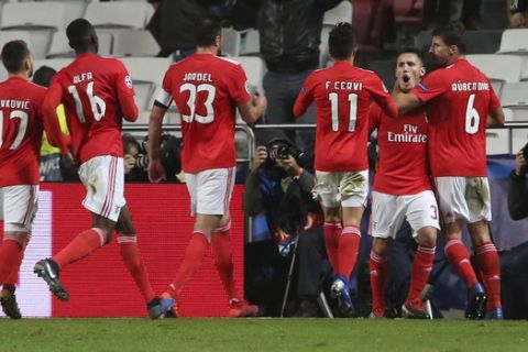 Benfica's Alex Grimaldo, 2nd from right, celebrates after he scored his side opening goal during the Champions League group E soccer match between Benfica and AEK Athens at the Luz stadium in Lisbon, Wednesday, Dec. 12, 2018. (AP Photo/Armando Franca)