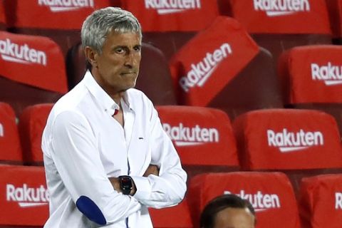 Barcelona's head coach Quique Setien is seen during a Spanish La Liga soccer match between Barcelona and Osasuna at the Camp Nou stadium in Barcelona, Spain, Thursday, July 16, 2020. (AP Photo/Joan Monfort)