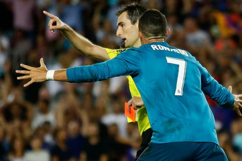 Real Madrid's Cristiano Ronaldo, right, reacts after referee Ricardo de Burgos shows a red card during the Spanish Supercup, first leg, soccer match between FC Barcelona and Real Madrid at Camp Nou stadium in Barcelona, Spain, Sunday, Aug. 13, 2017. (AP Photo/Manu Fernandez)