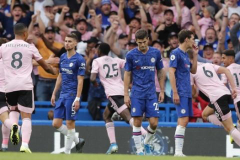 Chelsea players react after Leicester's Wilfred Ndidi, background center, scored his side's first goal during the English Premier League soccer match between Chelsea and Leicester City at Stamford Bridge stadium in London, Sunday, Aug. 18, 2019. (AP Photo/Frank Augstein)