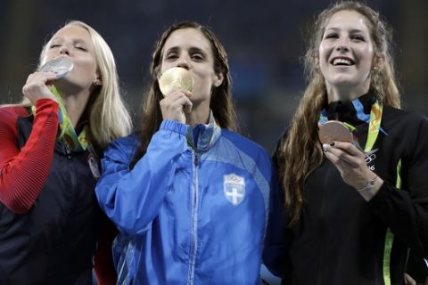Women's pole vault medalists, from left, United States' Sandi Morris, silver, Greece's Ekaterini Stefanidi, gold, and New Zealand's Eliza McCartney, bronze, hold their medals on the podium during the Summer Olympics at Olympic stadium in Rio de Janeiro, Brazil, Saturday, Aug. 20, 2016. (AP Photo/Jae C. Hong)