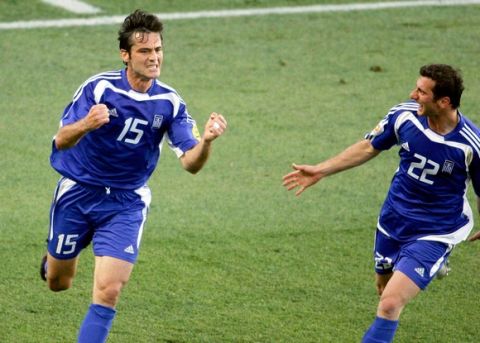 epa000216215 Greek Zisis Vryzas (L) celebrates with his team mate Dimitrios Papadopoulos (R) after scoring his team's first goal against Russia during their Group A match as part of the European Soccer Championship at the Algarve stadium in Faro, Portugal, Sunday 20 June 2004. Russia and Greece play their third group match of the Euro2004, which will end on July 04.  EPA/ANTONIO SIMOES +++ NO MOBILE APPLICATIONS +++