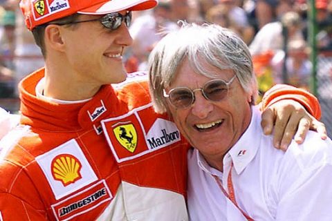 FILE - In this aug. 12, 2000 file picture, Ferrari driver Michael Schumacher of Germany, left, celebrates with F1 supremo Bernie Ecclestone after the qualifying session of the 15th Formula One Hungarian Grand Prix on the Hungaroring racetrack in Mogyorod, some 20 kilometers (12 miles) northeast of Budapest. Seven-time Formula One champion Schumacher is making a comeback for Ferrari to replace injured driver Felipe Massa it was announced Wednesday July 29, 2009. Schumacher will get back in the cockpit until Massa is fit to return. The next race is the European Grand Prix on Aug. 23 in Valencia.  (AP Photo/ Noemi Bruzak)