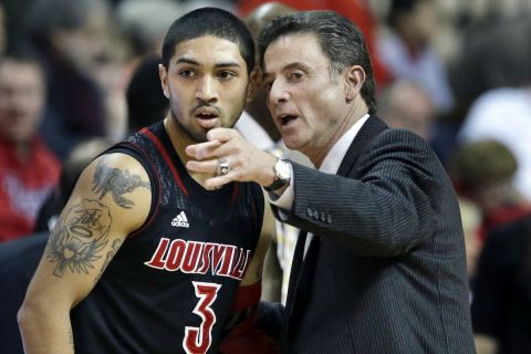 Louisville head coach Rick Pitino, right, talks with Peyton Siva (3) during the first half of an NCAA college basketball game against Rutgers, Wednesday, Feb. 6, 2013, in Piscataway, N.J. Louisville won 68-48. (AP Photo/Mel Evans)