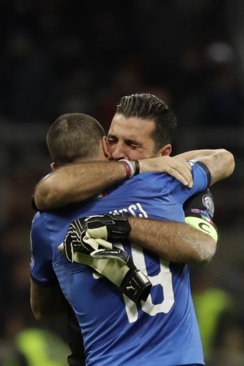 Italy goalkeeper Gianluigi Buffon is hugged by teammate Andrea Belotti after their team was eliminated in the World Cup qualifying play-off second leg soccer match between Italy and Sweden, at the Milan San Siro stadium, Italy, Monday, Nov. 13, 2017. (AP Photo/Luca Bruno)
