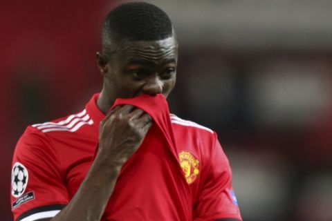 Manchester United's Eric Bailly wipes his face as he walks from the pitch after the end of the Champions League round of 16 second leg soccer match between Manchester United and Sevilla, at Old Trafford in Manchester, England, Tuesday, March 13, 2018. Sevilla won the game 2-1 and go through to the quarterfinals .(AP Photo/Dave Thompson)