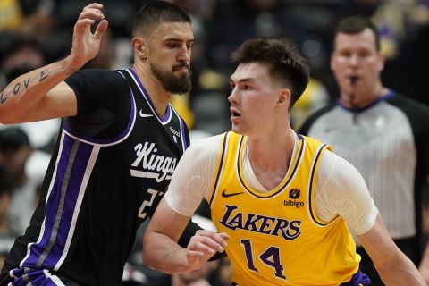 Los Angeles Lakers center Colin Castleton, right, works against Sacramento Kings center Alex Len during the second half of a preseason NBA basketball game Wednesday, Oct. 11, 2023, in Anaheim, Calif. (AP Photo/Ryan Sun)