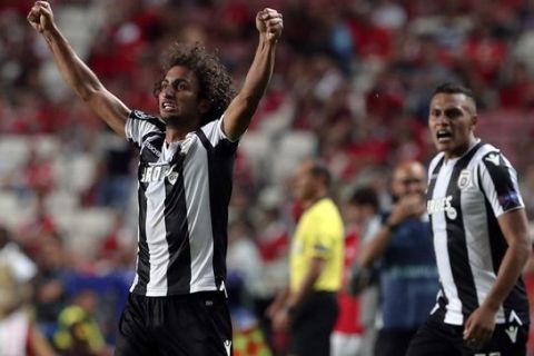 PAOK's Amr Warda, center, celebrates scoring his side's first goal during the Champions League playoffs, first leg, soccer match between Benfica and PAOK at the Luz stadium in Lisbon, Tuesday, Aug. 21, 2018. (AP Photo/Armando Franca)