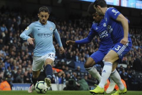 Manchester City's Bernardo Silva, left, is challenged by Leicester's Hamza Choudhury, center and Leicester's Ben Chilwell during the English Premier League soccer match between Manchester City and Leicester City at the Etihad stadium in Manchester, England, Monday, May 6, 2019. (AP Photo/Rui Vieira)