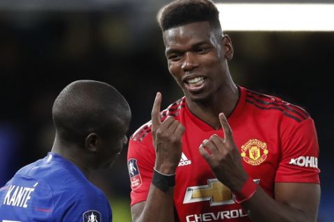 Manchester United's Paul Pogba, right, talks to Chelsea's N'Golo Kante after the English FA Cup fifth round soccer match between Chelsea and Manchester United at Stamford Bridge stadium in London, Monday, Feb. 18, 2019. (AP Photo/Alastair Grant)