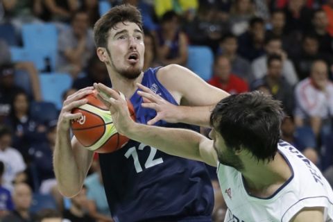 France's Nando De Colo (12) is pressured by Serbia's Milos Teodosic (4) during a men's basketball game at the 2016 Summer Olympics in Rio de Janeiro, Brazil, Wednesday, Aug. 10, 2016. (AP Photo/Eric Gay)