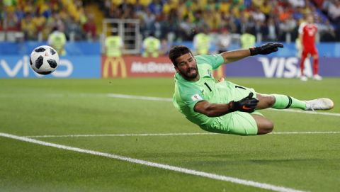 Brazil goalkeeper Alisson dives for the ball during the group E match between Serbia and Brazil, at the 2018 soccer World Cup in the Spartak Stadium in Moscow, Russia, Wednesday, June 27, 2018. (AP Photo/Rebecca Blackwell)