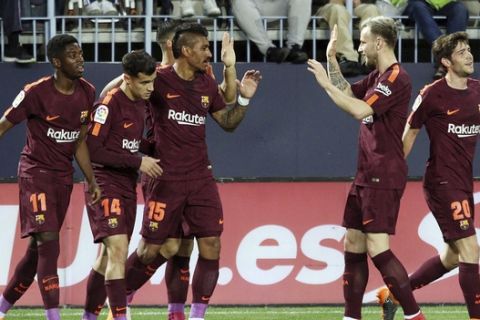 Barcelona's Coutinho celebrates with team mates scoring his side's 2nd goal during a Spanish La Liga soccer match between Malaga and Barcelona in Malaga, Spain, Saturday, March 10, 2018. (AP Photo/M.Pozo)