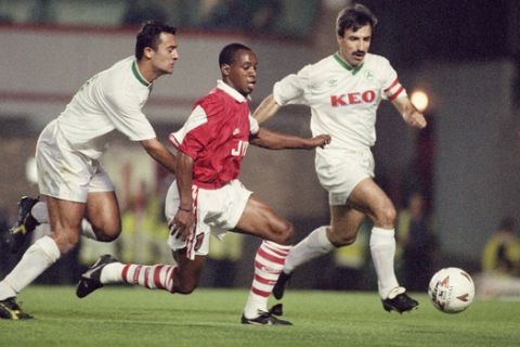 Ian Wright of Arsenal runs between two unidentified Omonia Nicosia players during their European Cup Winners Cup 1st round 2nd leg match at Highbury, North London, Thursday, Sept. 29, 1994. Arsenals were leading 3-1 after the 1st leg. (AP Photo/Alistair Grant)