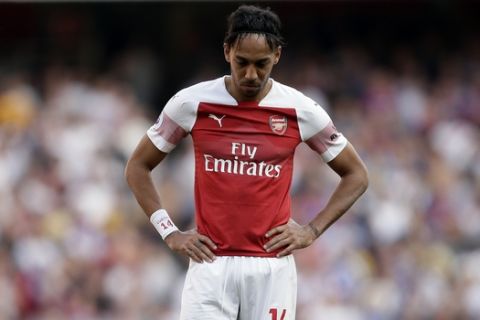 Arsenal's Pierre-Emerick Aubameyang reacts during the English Premier League soccer match between Arsenal and Crystal Palace at the Emirates Stadium in London, Sunday, April 21, 2019. (AP Photo/Tim Ireland)