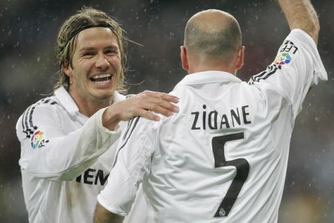 FILE - This is a Sunday, Jan. 15, 2006 file photo of Real Madrid's David Beckham, left, as he congratulates  goalscorer Zinedine Zidane  during their Spanish league soccer match against Sevilla  at the Santiago Bernabeu Stadium in Madrid, Spain.  David Beckham is retiring from soccer after the season, ending a career in which he become a global superstar since starting his career at Manchester United. The 38-year-old Englishman recently won a league title in a fourth country with Paris Saint-Germain. He said in a statement Thursday May 16, 2013  he is "thankful to PSG for giving me the opportunity to continue but I feel now is the right time to finish my career, playing at the highest level." (AP Photo/Bernat Armangue, File)