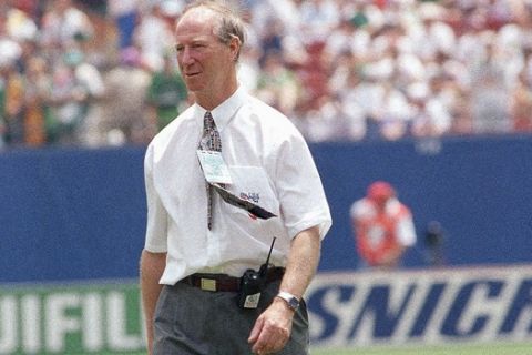 Irish coach Jack Charlton, with a radio phone at his belt, leaves the pitch en route to the stands at Giants Stadium, East Rutherford, N.J., on Tuesday, June 28, 1994 shortly before the Ireland Vs. Norway Group E World Cup soccer opening round match. Charlton has been banned from the field by FIFA (International Federation of Football Association) for allegedly arguing with a FIFA official during Ireland?s match against Mexico on the substitution of Irish player John Aldrige. Charlton will watch the game from a box in the stands and radio instructions to his assistant officially coaching the team. (AP Photo/Gianni Foggia)